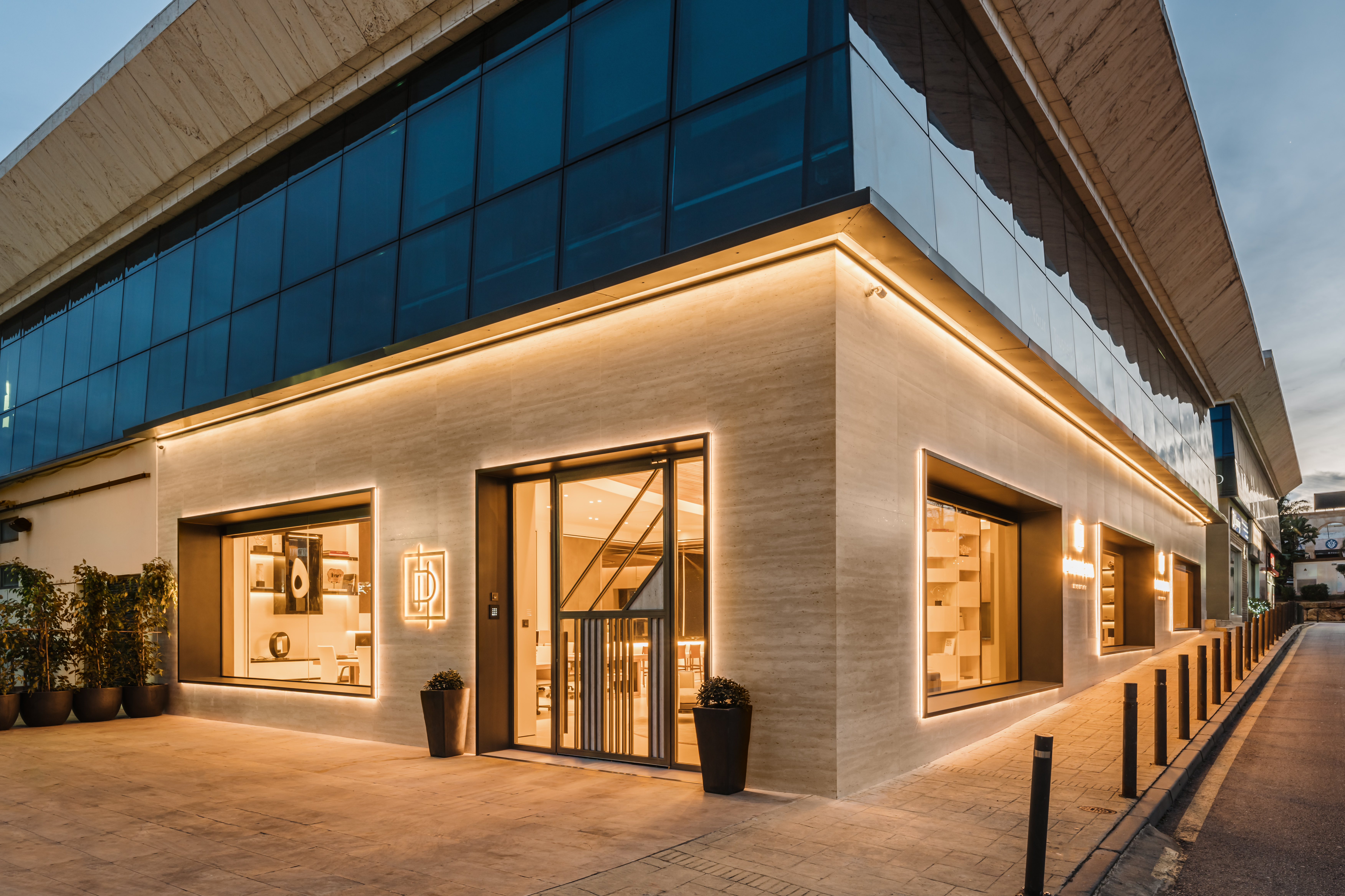 Photograph of the exterior facade of the Drumelia Office at night in Marbella